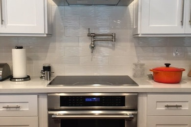 This is an example of a kitchen in Miami with stainless steel appliances.