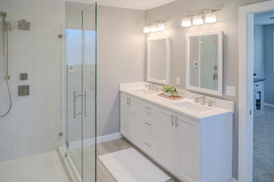 Corner shower - mid-sized craftsman master gray tile and ceramic tile ceramic tile, gray floor and double-sink corner shower idea in Salt Lake City with shaker cabinets, white cabinets, an undermount tub, a bidet, gray walls, an undermount sink, quartz countertops, a hinged shower door, white countertops, a niche and a built-in vanity