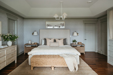 Mid-sized beach style master dark wood floor, brown floor and wallpaper bedroom photo in Toronto with blue walls