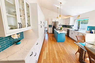 Example of a large beach style vaulted ceiling eat-in kitchen design in San Diego with a single-bowl sink, shaker cabinets, white cabinets, quartz countertops, blue backsplash, glass tile backsplash, stainless steel appliances, an island and turquoise countertops