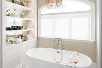 Inspiration for a mid-sized traditional master bathroom in Toronto with brown cabinets, a freestanding tub, an open shower, beige walls, marble floors, an undermount sink, engineered quartz benchtops, beige floor, a hinged shower door, white benchtops, an enclosed toilet, a double vanity, a built-in vanity and wallpaper.