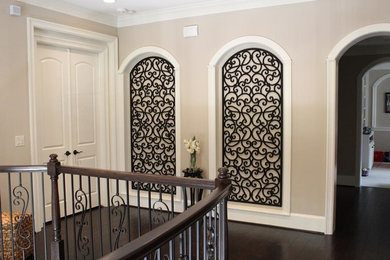 Tuscan dark wood floor hallway photo in Houston with white walls