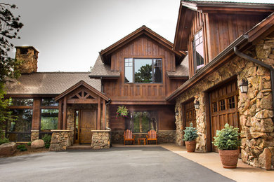Inspiration for a large rustic brown two-story wood exterior home remodel in Denver with a shingle roof