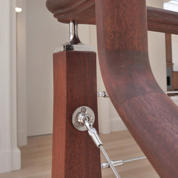 Dark wood staircase with wire cables