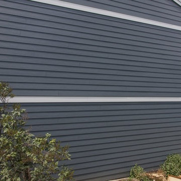 Shiny new Andersen Windows, Evening Blue James Hardie siding & stone accents
