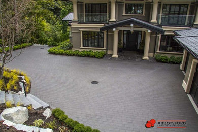 Large arts and crafts front yard partial sun driveway in Vancouver with a garden path and brick pavers for spring.
