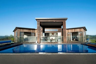 Contemporary rectangular infinity pool in Auckland with decking.