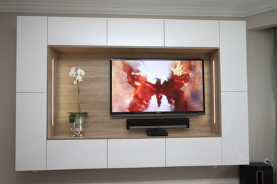 Inspiration for a large modern enclosed home theatre in Miami with white walls and a built-in media wall.