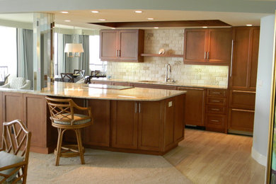 Inspiration for a mid-sized coastal l-shaped light wood floor and beige floor eat-in kitchen remodel in Miami with an undermount sink, medium tone wood cabinets, granite countertops, stone tile backsplash, stainless steel appliances, an island, shaker cabinets and beige backsplash
