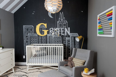 Small modern nursery in Austin with grey walls and dark hardwood floors for boys.