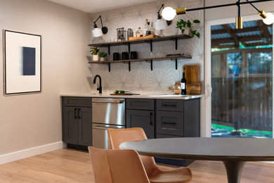 Home bar - mid-sized home bar idea in Seattle with shaker cabinets, gray cabinets and quartz countertops