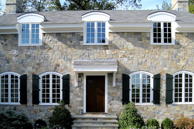 Large traditional two-story stone exterior home idea in Boston with a shingle roof