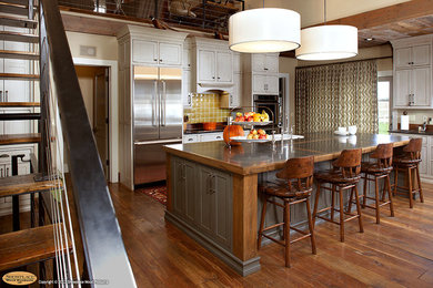 Eat-in kitchen - rustic eat-in kitchen idea in Other with a farmhouse sink, beaded inset cabinets, green cabinets, limestone countertops, yellow backsplash and stainless steel appliances