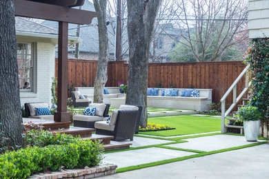 Inspiration for a mid-sized modern backyard partial sun formal garden for spring in Dallas with a fire feature and concrete pavers.