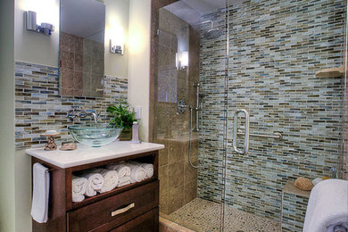 Small transitional 3/4 gray tile and glass tile limestone floor bathroom photo in Other with a vessel sink, recessed-panel cabinets, dark wood cabinets, quartz countertops, a two-piece toilet and beige walls