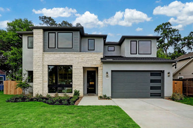 Large trendy gray two-story stucco and clapboard house exterior photo in Houston with a hip roof, a shingle roof and a black roof