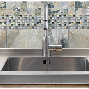 Photo of a large modern galley eat-in kitchen in Boston with an integrated sink, flat-panel cabinets, beige cabinets, zinc benchtops, grey splashback, stone tile splashback, stainless steel appliances and no island.