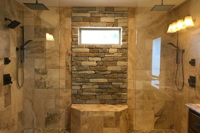 Inspiration for a large craftsman master beige tile and porcelain tile pebble tile floor and beige floor bathroom remodel in Houston with dark wood cabinets and granite countertops