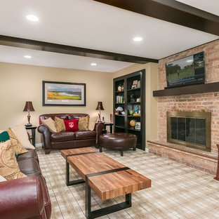 Photo of an expansive traditional look-out basement in Chicago with yellow walls, carpet, a standard fireplace, a brick fireplace surround and multi-coloured floors.