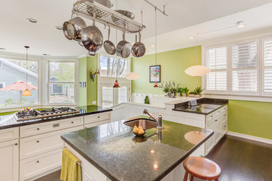 Example of a mid-sized trendy u-shaped dark wood floor eat-in kitchen design in Denver with a double-bowl sink, raised-panel cabinets, white cabinets, granite countertops, stone tile backsplash, stainless steel appliances and an island