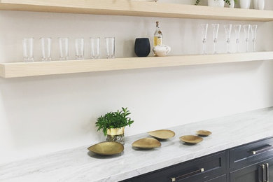 This is an example of a country wet bar in San Francisco with shaker cabinets, grey cabinets, marble benchtops and white splashback.