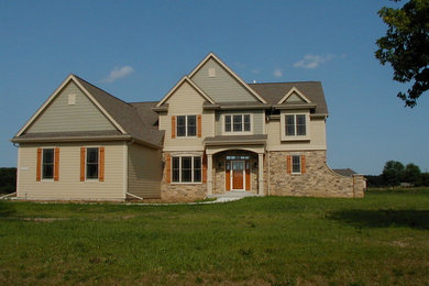 Inspiration for a large craftsman beige two-story mixed siding exterior home remodel in Other with a shingle roof