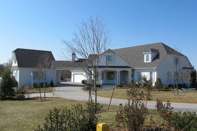 Mid-sized elegant white two-story brick exterior home photo in Detroit with a clipped gable roof