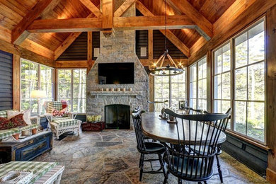Dining room - rustic dining room idea in Toronto with a standard fireplace and a stone fireplace