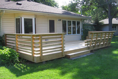 Example of a mid-sized classic backyard patio design in Minneapolis with decking and no cover