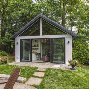 Design ideas for a small modern two-storey stucco grey exterior in DC Metro with a gable roof, a metal roof and a black roof.