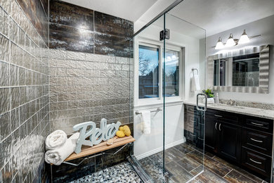 Corner shower - large contemporary master porcelain tile corner shower idea in Denver with raised-panel cabinets, dark wood cabinets, gray walls, an undermount sink and quartzite countertops