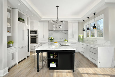 Open concept kitchen - mid-sized transitional l-shaped medium tone wood floor open concept kitchen idea in Toronto with a single-bowl sink, shaker cabinets, marble countertops, white backsplash, stone slab backsplash, paneled appliances and an island