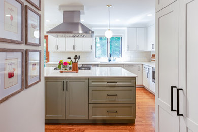 Inspiration for a mid-sized transitional u-shaped medium tone wood floor and brown floor eat-in kitchen remodel in Chicago with an undermount sink, shaker cabinets, white cabinets, quartzite countertops, white backsplash, ceramic backsplash, stainless steel appliances, an island and white countertops