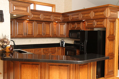 Mid-sized minimalist u-shaped eat-in kitchen photo in Other with medium tone wood cabinets and black appliances
