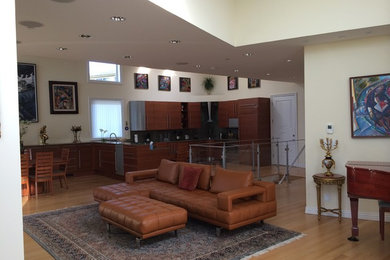 Inspiration for a contemporary open concept light wood floor family room remodel in San Francisco with beige walls