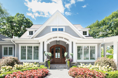 Example of a beach style home design design in Grand Rapids