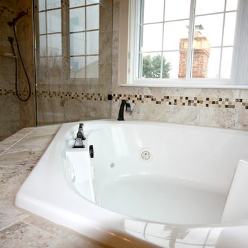 Master Bathroom with Frameless Shower and Jetted Tub