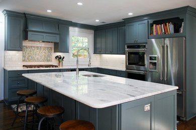 Large transitional l-shaped dark wood floor and brown floor enclosed kitchen photo in DC Metro with an undermount sink, shaker cabinets, blue cabinets, marble countertops, white backsplash, subway tile backsplash, stainless steel appliances and an island