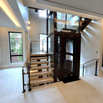 Project #136 | Modern Floating Staircase Encircling Glass Elevator
