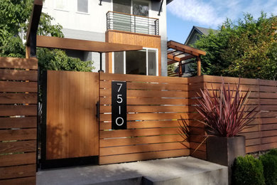 Photo of a contemporary full sun front yard concrete paver and wood fence garden path in Seattle for fall.