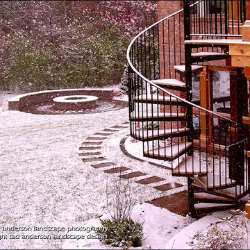 Dramatic Spiral Stair Connects Upper Level Deck to Back Yard. Minnesota Landscap