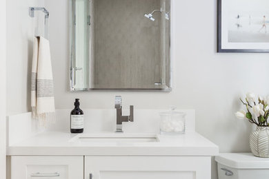 Bathroom - mid-sized transitional beige tile and ceramic tile porcelain tile and gray floor bathroom idea in Los Angeles with shaker cabinets, white cabinets, gray walls, an undermount sink and quartz countertops