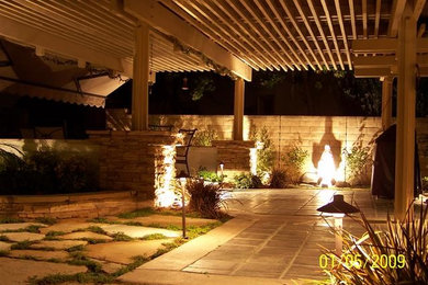 Design ideas for a medium sized classic back xeriscape partial sun garden for spring in Orange County with a garden path and natural stone paving.