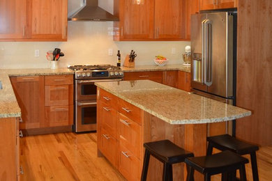 Inspiration for a mid-sized craftsman u-shaped light wood floor and brown floor eat-in kitchen remodel in Seattle with an undermount sink, shaker cabinets, light wood cabinets, granite countertops, white backsplash, ceramic backsplash, stainless steel appliances and an island