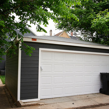 Modern Residential Garage with White Door and Tree-Lined Surroundings