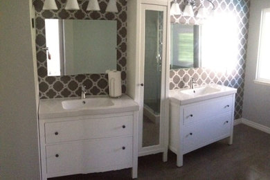 Large trendy master gray tile and porcelain tile porcelain tile corner shower photo in Los Angeles with an integrated sink, furniture-like cabinets, white cabinets, solid surface countertops, a two-piece toilet and gray walls