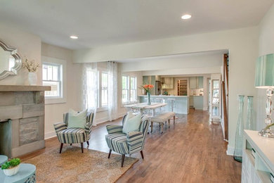 Inspiration for a mid-sized transitional open concept medium tone wood floor and gray floor living room remodel in Nashville with white walls, a standard fireplace, a stone fireplace and no tv