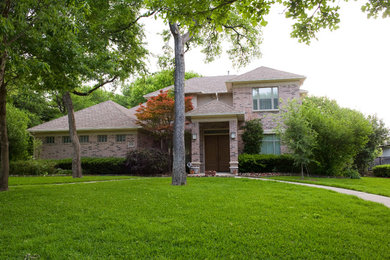 Multicolored two-story brick house exterior photo in Dallas with a shingle roof