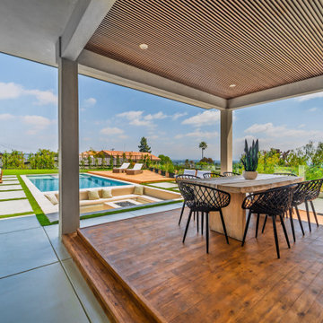 Covered Patio Raised on a Timber Platform Beside the Pool