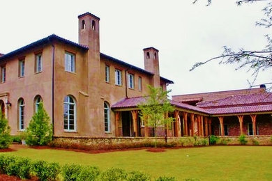 Inspiration for a large mediterranean beige two-story stucco exterior home remodel in Atlanta